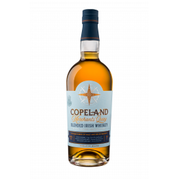 A bottle of Merchants' Quay blended Irish whiskey by Copeland Distillery, with a still from the distillery in the background.