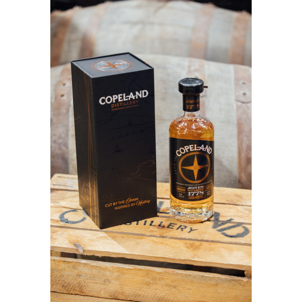 A Bottle of Jones 1778 Navy Strength Gin sitting beside a beautiful branded gift box that can be purchased from Copeland Distillery as a gift set.